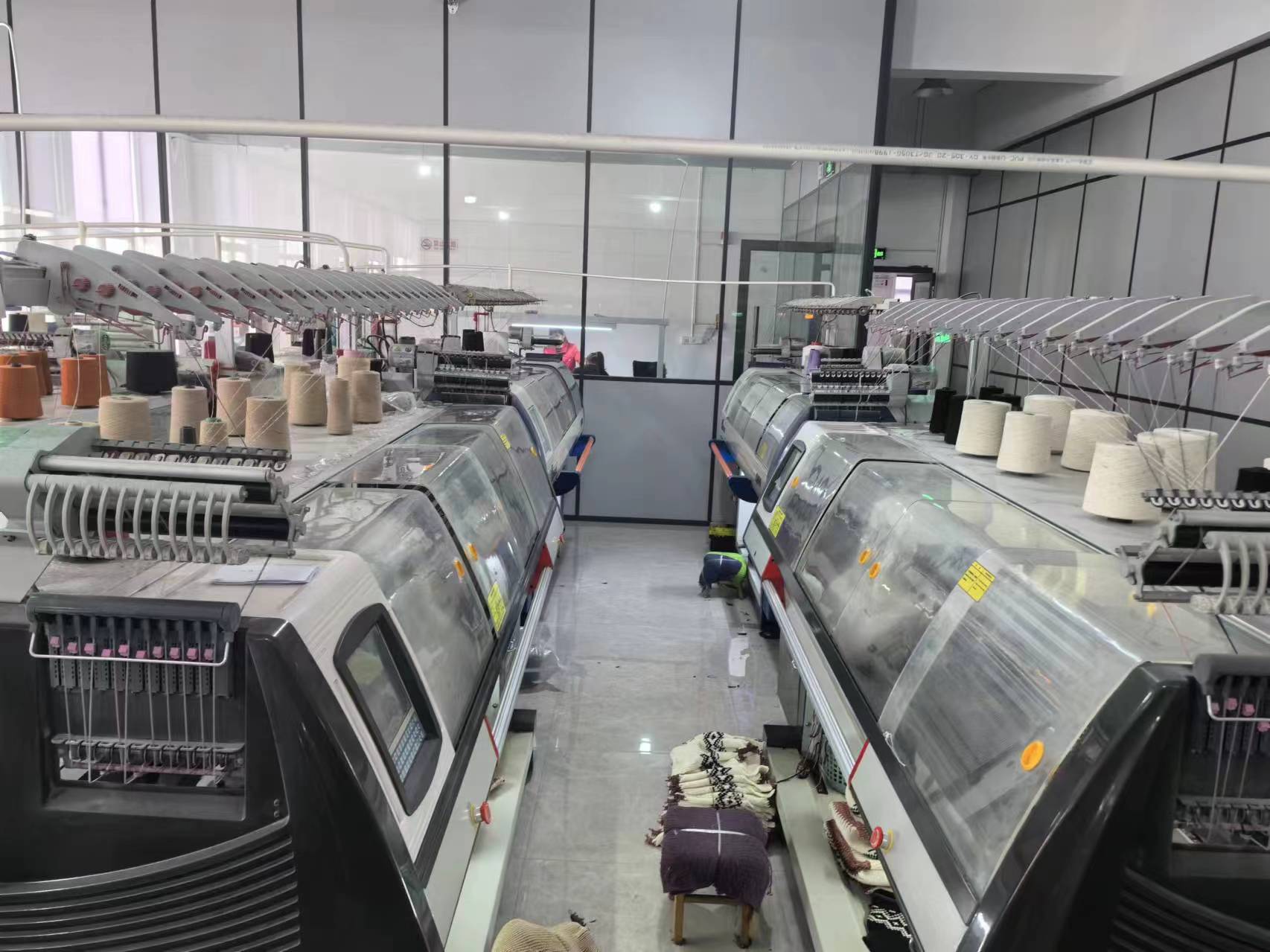 Clean knitting production environment with yarn cones and knitting machines for custom beanie manufacturing